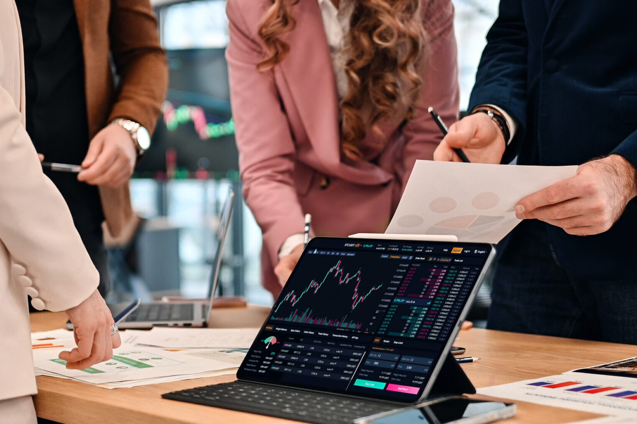 Business meeting in an office, workers discussing business affairs using gadgets and papers with charts